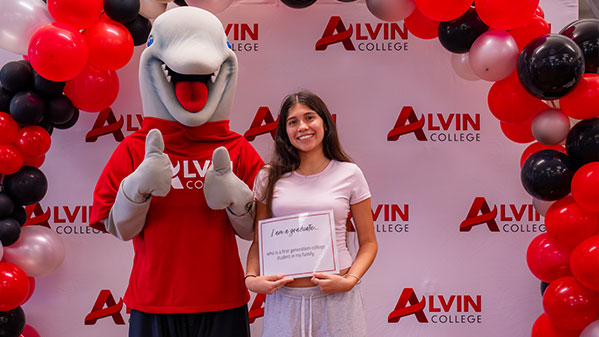 Picture of a graduate with Blue the mascot