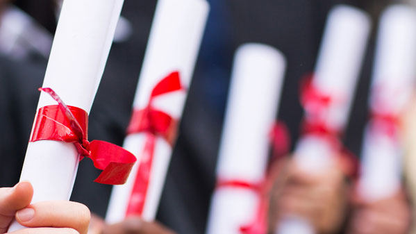 Graduates holding a diploma
